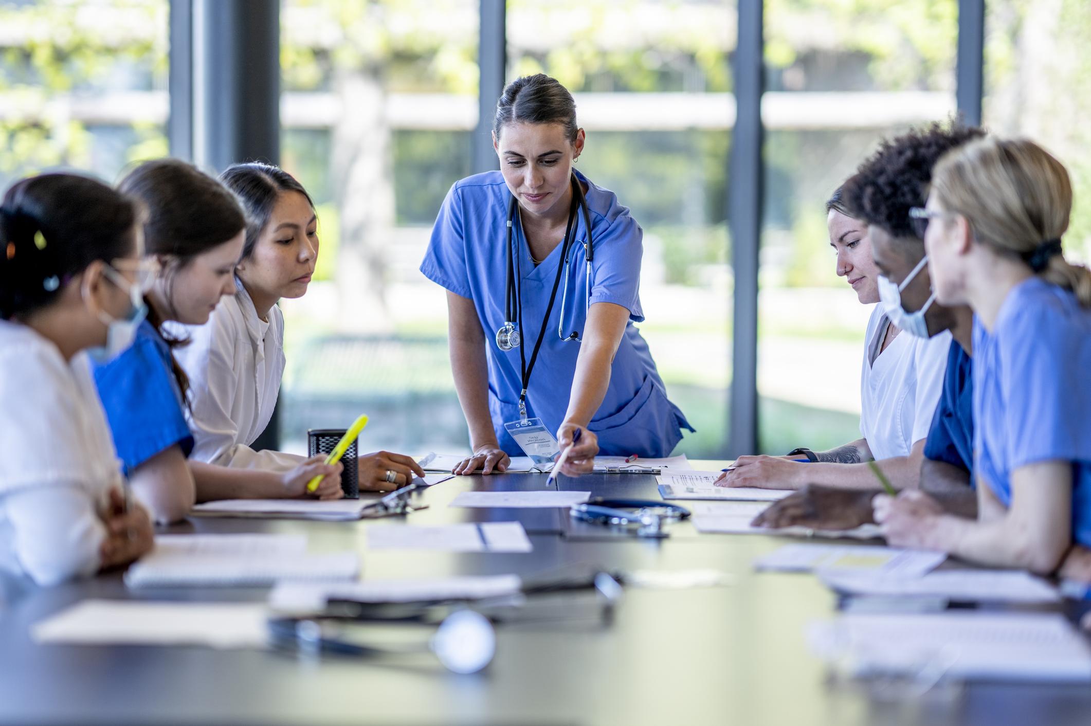 nurse talking to room full of nurses